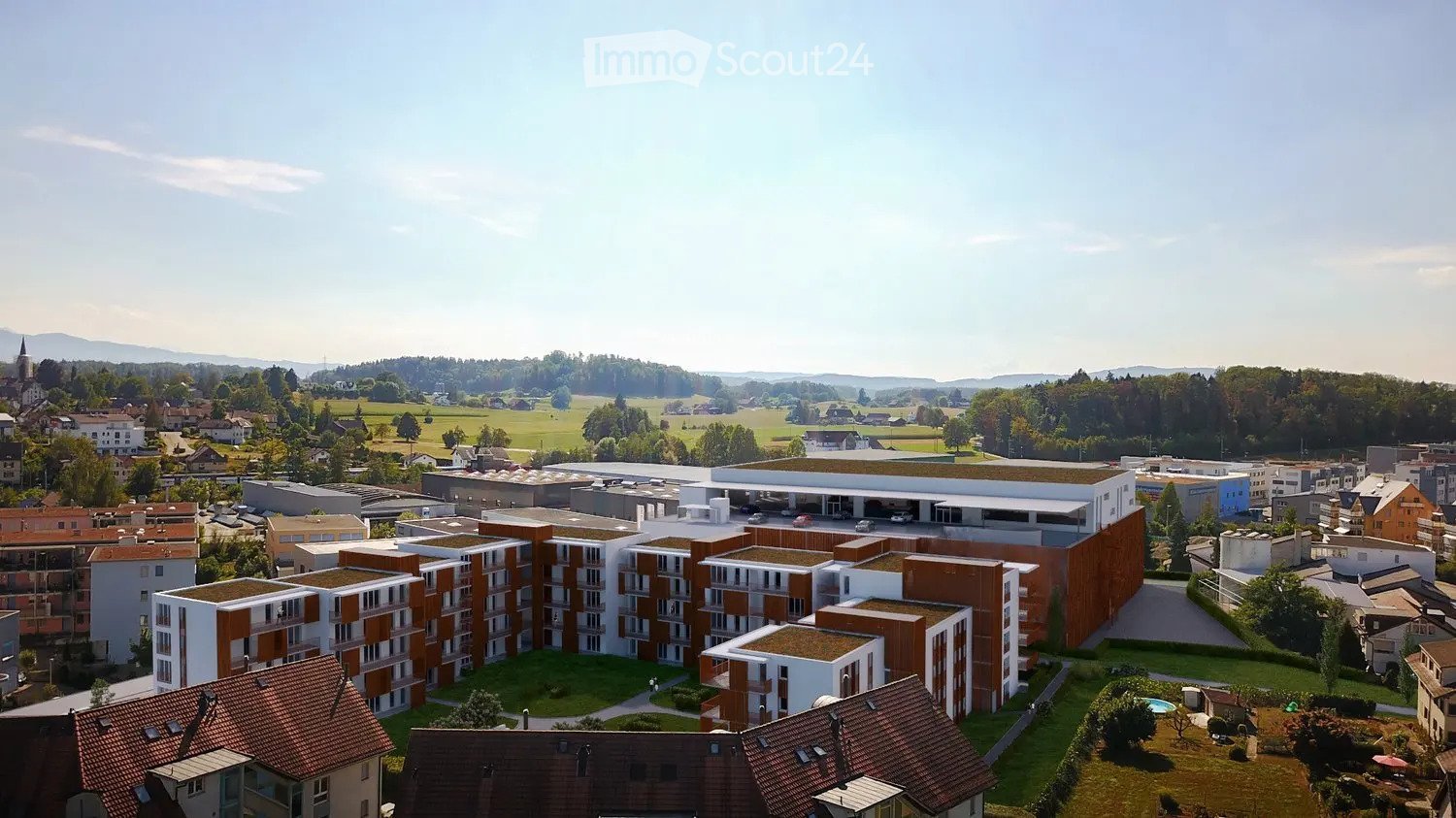 Aerial view of a modern residential complex with multiple apartment buildings, green spaces, and a swimming pool.