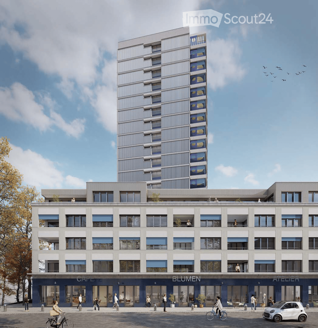 Modern multi-story building with contemporary design, featuring large windows, balconies, and commercial storefronts labeled "CAFE," "BLUMEN," and "ATELIER." The ground floor includes seating areas and bicycles.