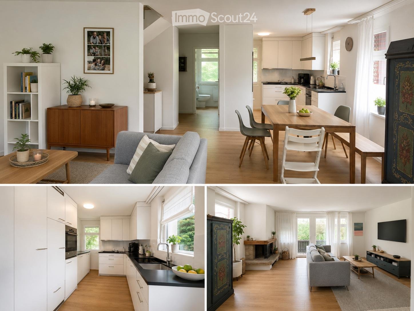 The image shows a modern, open-plan living and dining area with a grey sofa, coffee table, bookshelf, and cabinet. A dining table with chairs is visible, along with a kitchen area featuring white cabinets, a sink, and various appliances. A fireplace and t