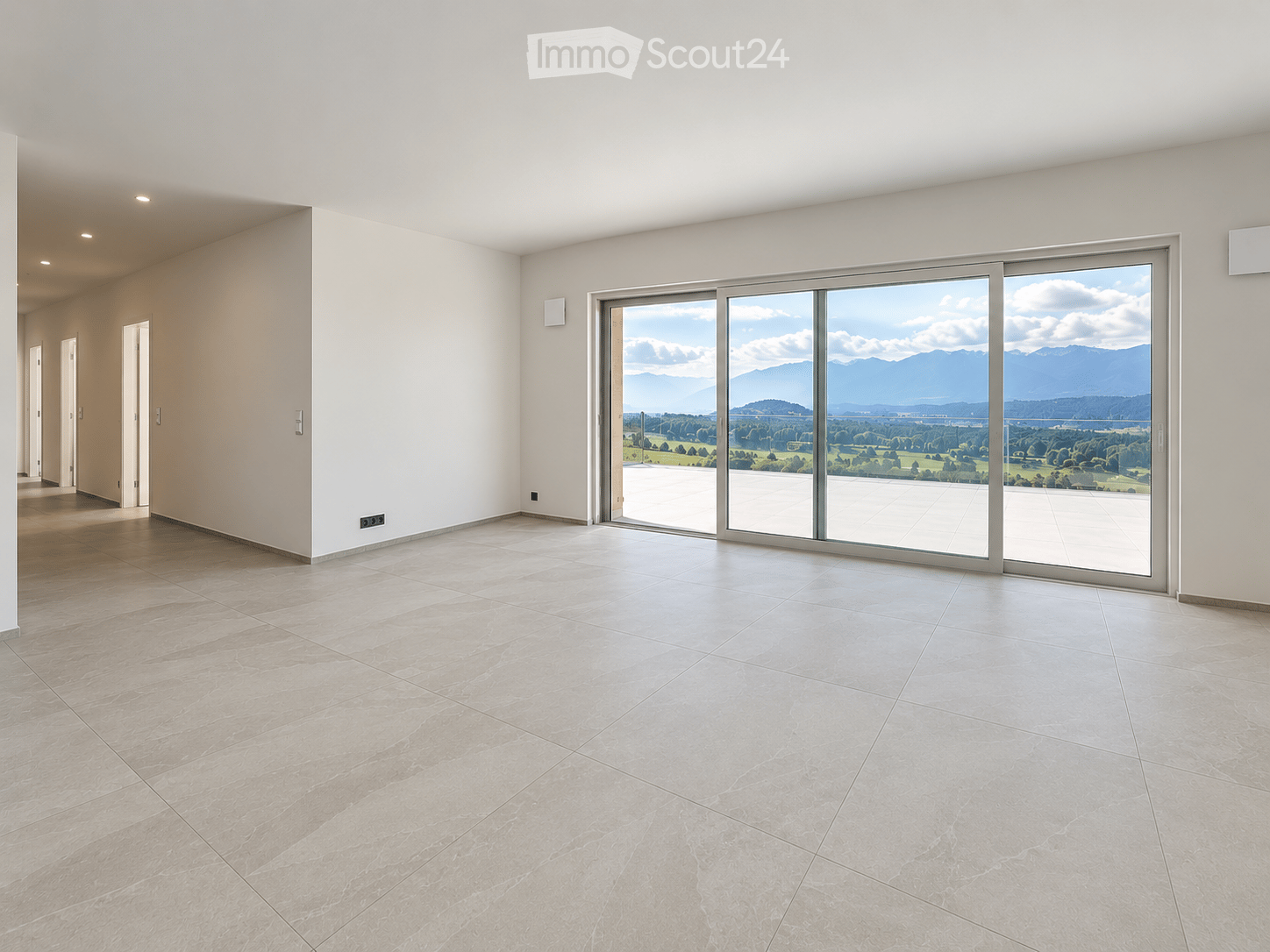 Empty room with large sliding glass doors leading to a balcony, tiled floor, and white walls.