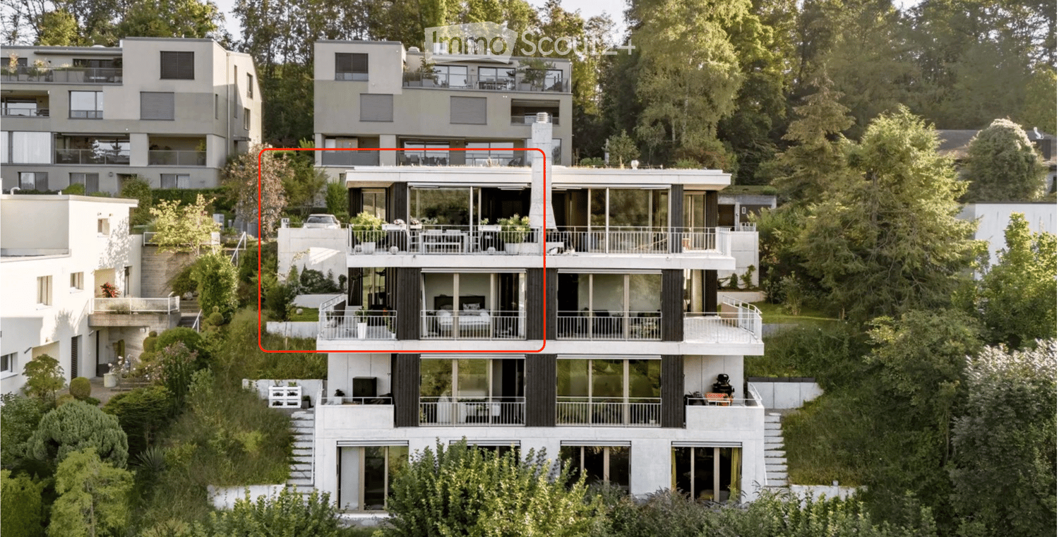 Modern multi-story residential building with large windows, balconies, and surrounding greenery.