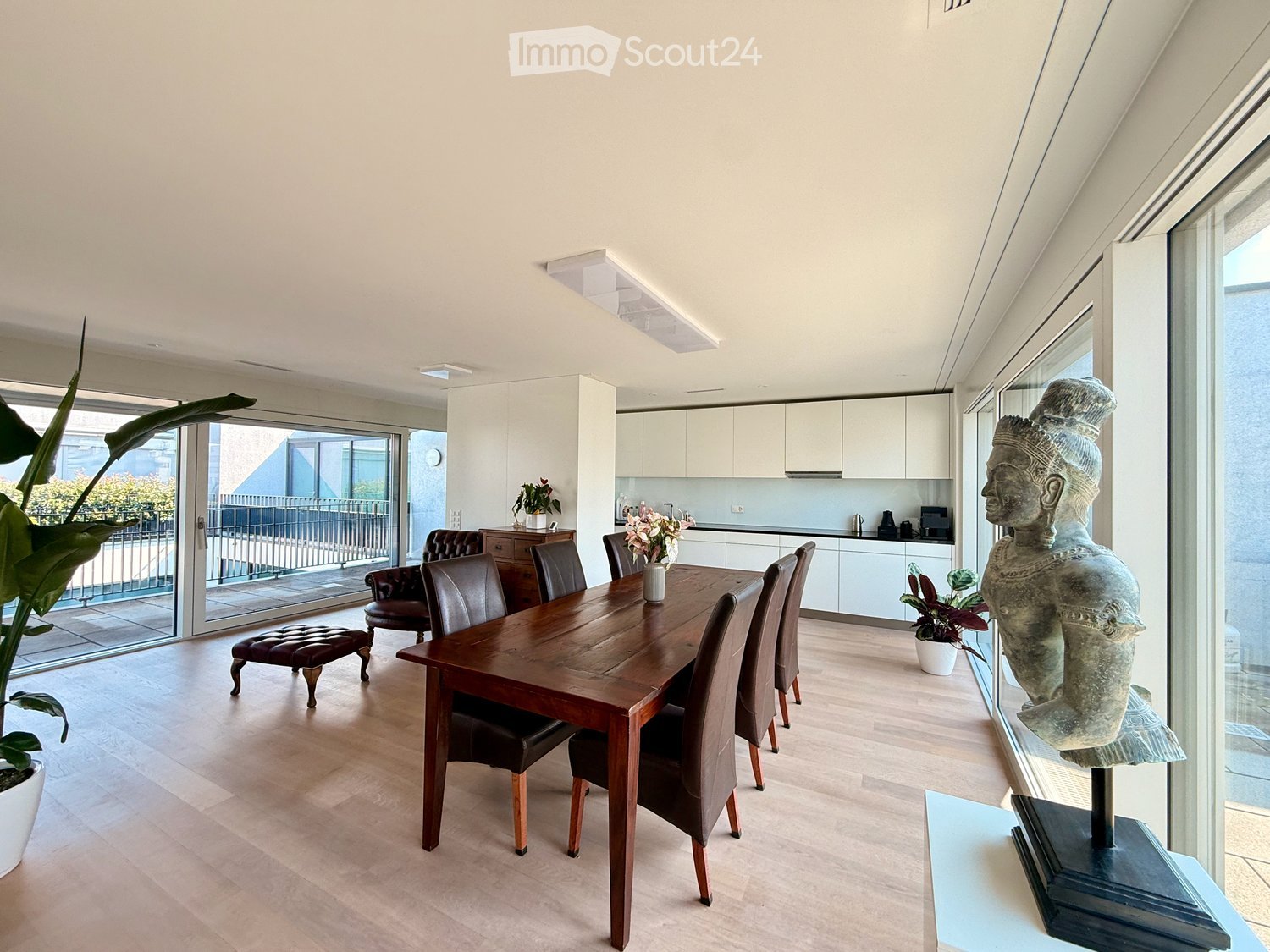 {"visible_features": ["Balcony / Terrace"], "type": "Furnished Room", "objects": ["dining table", "chair", "stool", "kitchen cabinet", "kitchen counter", "kitchen sink", "kitchen appliance", "kitchen faucet", "kitchen cabinet", "kitchen cabinet", "kitchen