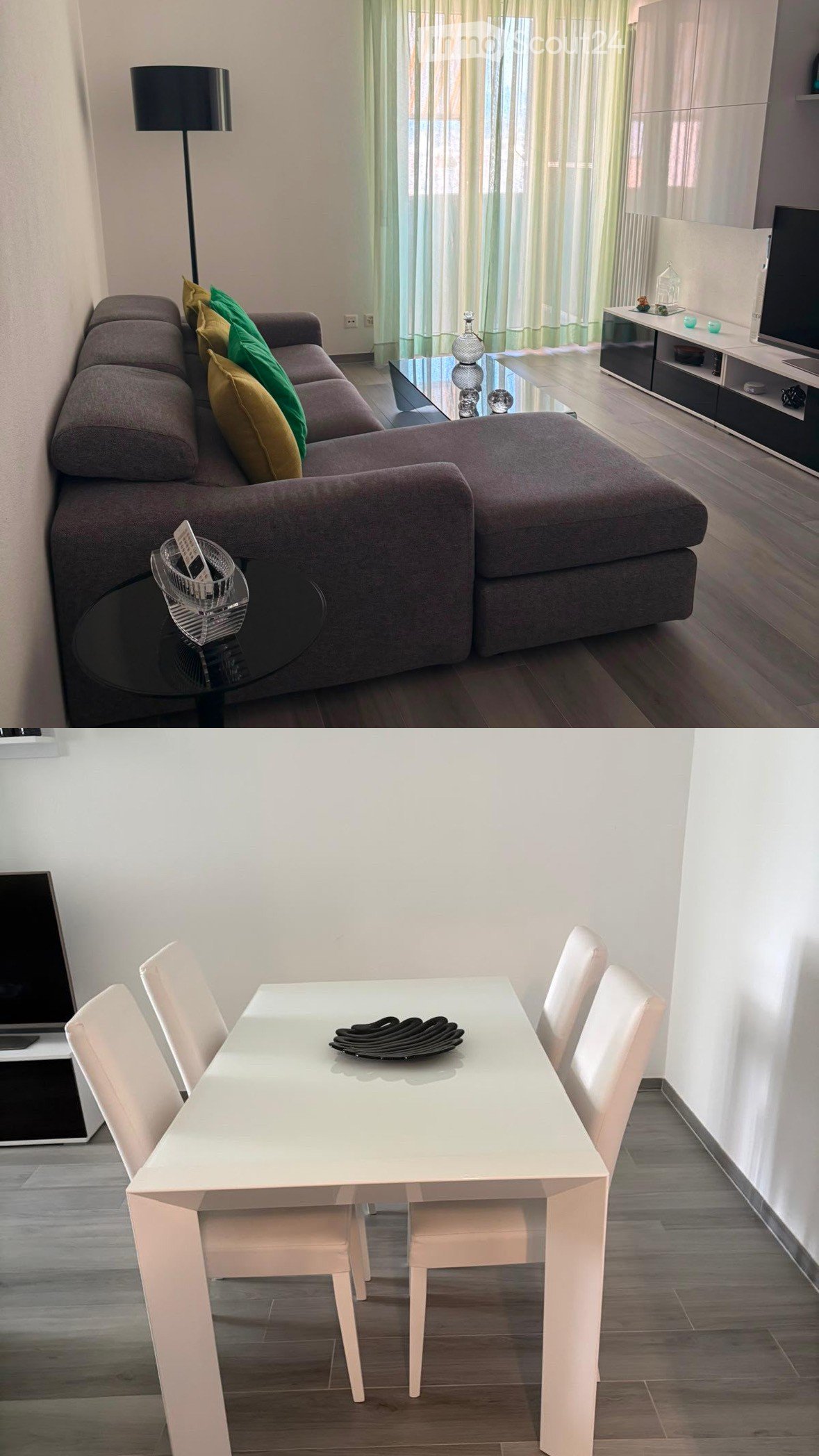 Modern living and dining area with a grey sectional sofa, glass coffee table, white dining table with four chairs, TV stand, and decorative items.
