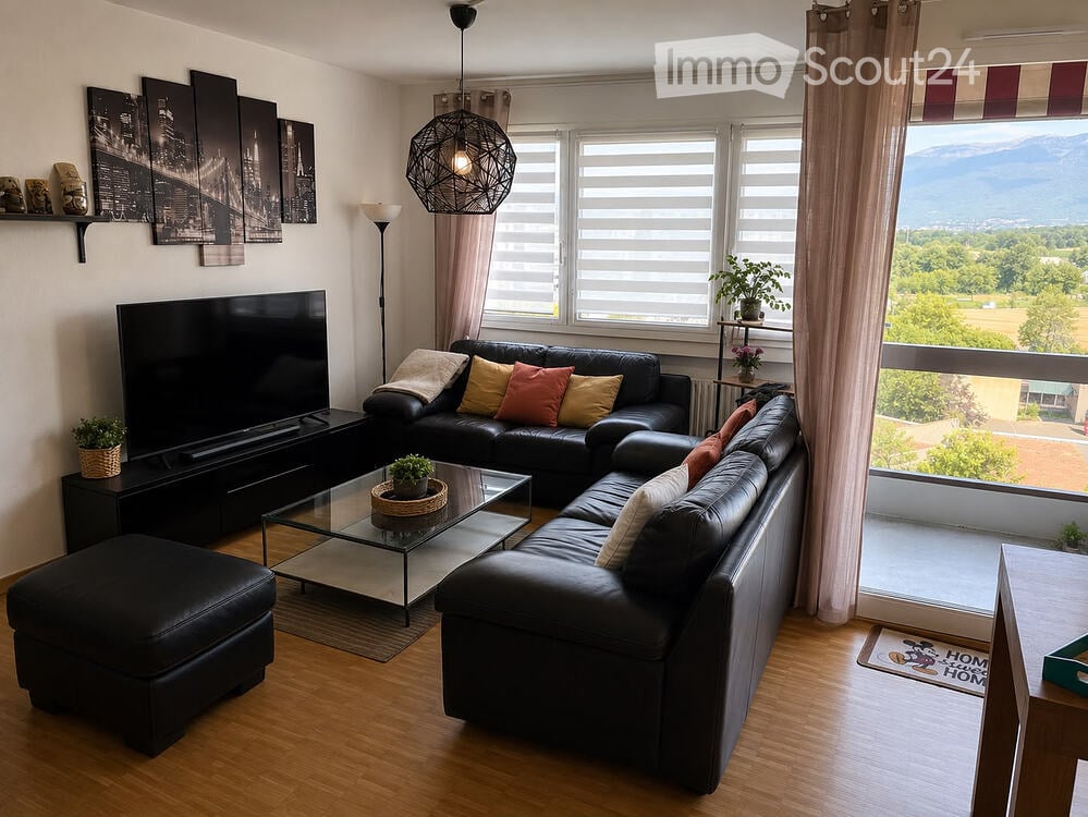 Modern living room with large windows offering a scenic view, featuring a black leather sectional sofa, glass coffee table, ottoman, floor lamp, TV stand, and decorative plants.