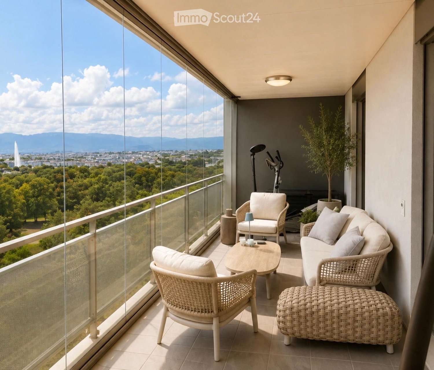 Balcony with a view of the city and mountains, featuring a sofa, chairs, a coffee table, a stool, a lamp, and a potted plant.