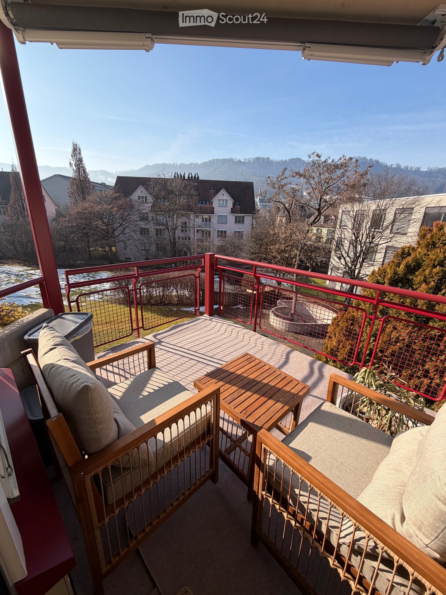 wooden chairs, wooden table, fence, city view