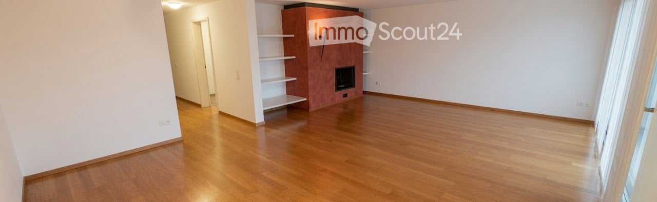 Empty room with wooden flooring, white walls, and a fireplace with built-in shelving. No furniture or equipment present.