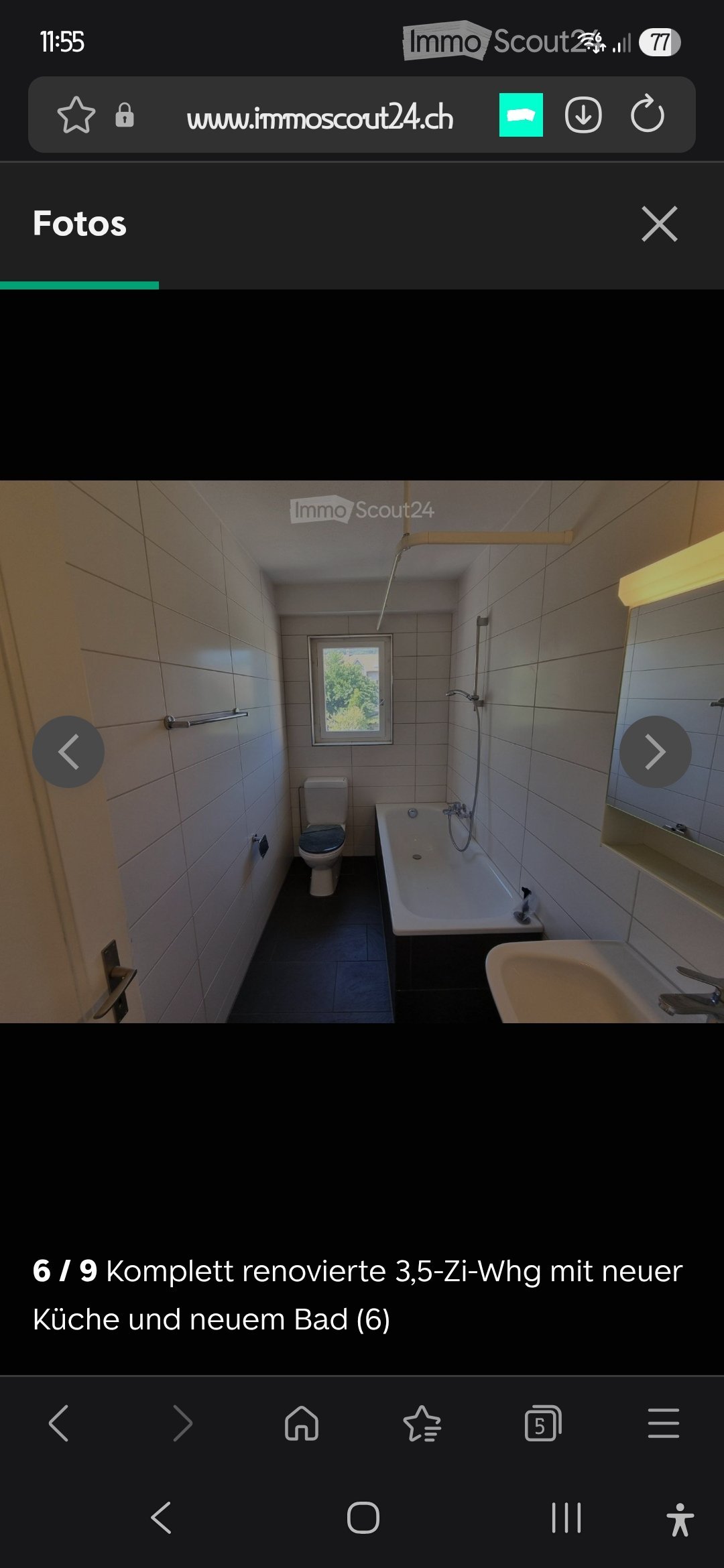 Modern bathroom with white tiled walls, a toilet, a bathtub, a sink, and a mirror. The room has a window providing natural light.