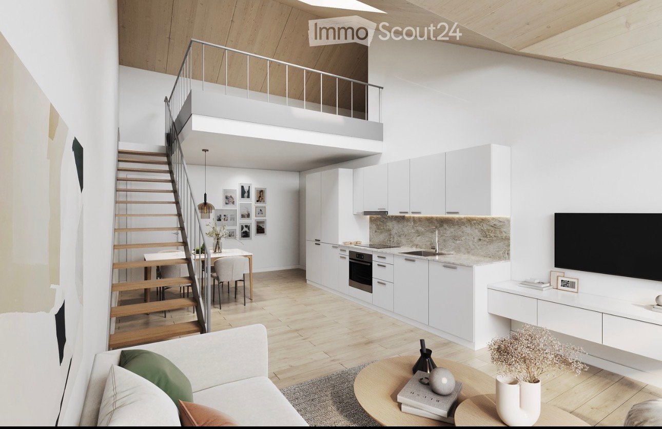 Modern open-plan living and dining area with a raised loft level, white kitchen cabinets, a sofa, coffee table, dining table, and decorative items.