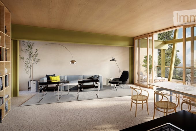 Modern living room with large windows offering a scenic view, featuring a grey sofa, coffee table, chairs, floor lamp, and a bookcase.