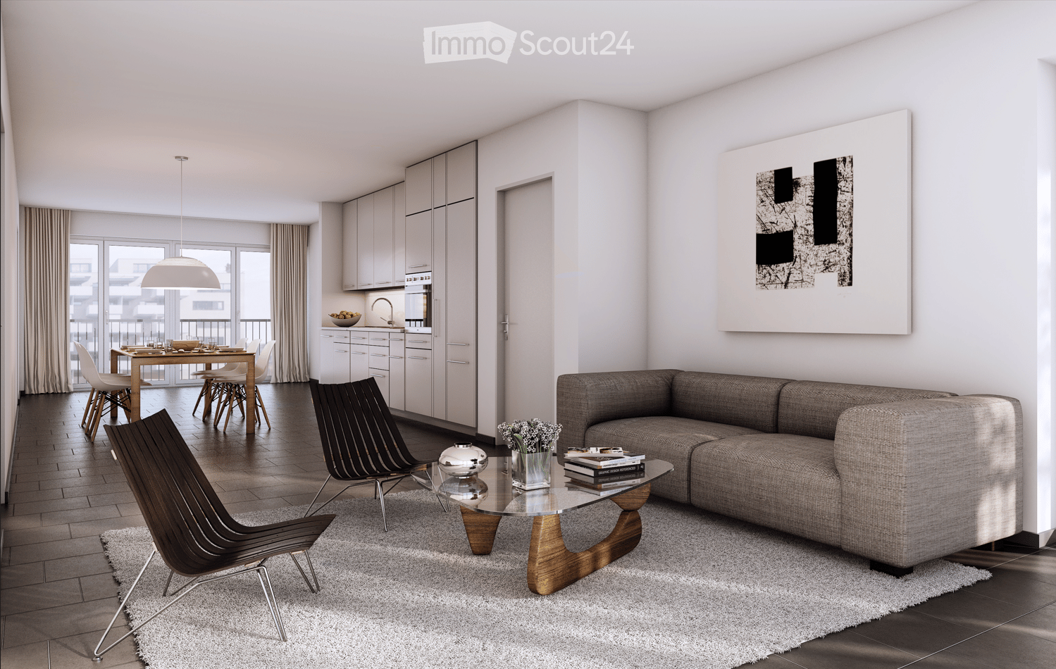 Modern living and dining area with a grey sofa, glass coffee table, wooden chairs, dining table, and kitchen area with cabinets and a bowl on the counter.