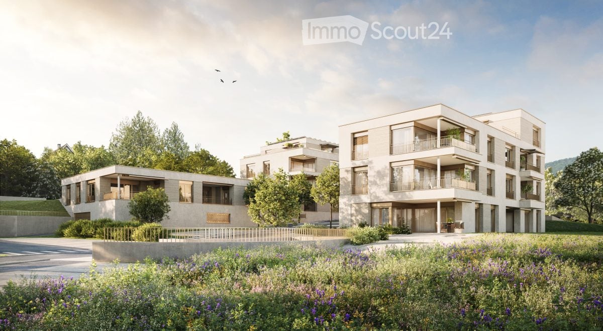 Modern multi-story residential building with balconies, surrounded by greenery and a landscaped garden area.