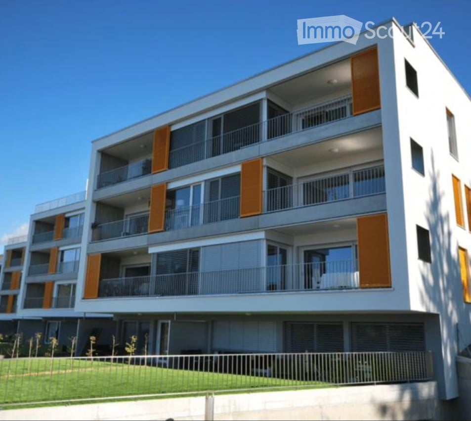 Modern multi-story apartment building with white facade, orange shutters, and balconies.