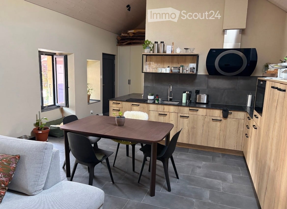 {"visible_features": [], "type": "Furnished Room", "objects": ["sofa", "table", "chair", "cupboard", "faucet", "microwave", "oven", "fridge", "cupboard", "cupboard", "cupboard", "cupboard", "cupboard", "cupboard", "cupboard", "cupboard", "cupboard", "cupb