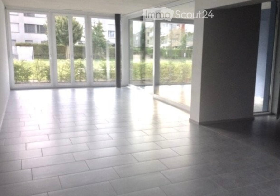 Empty room with large windows and tiled flooring, no furniture or equipment present.