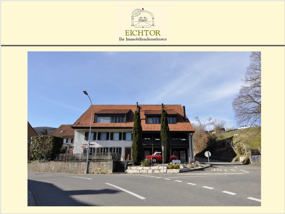 Building with red roof, white wall, multiple windows, staircase in front, parked red car