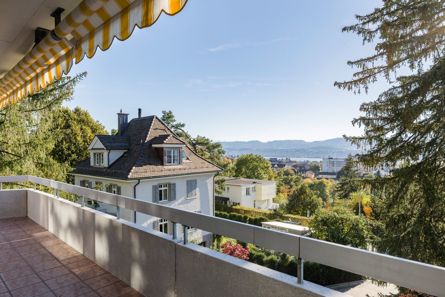 Tiled balcony with awning overlooking scenic landscape