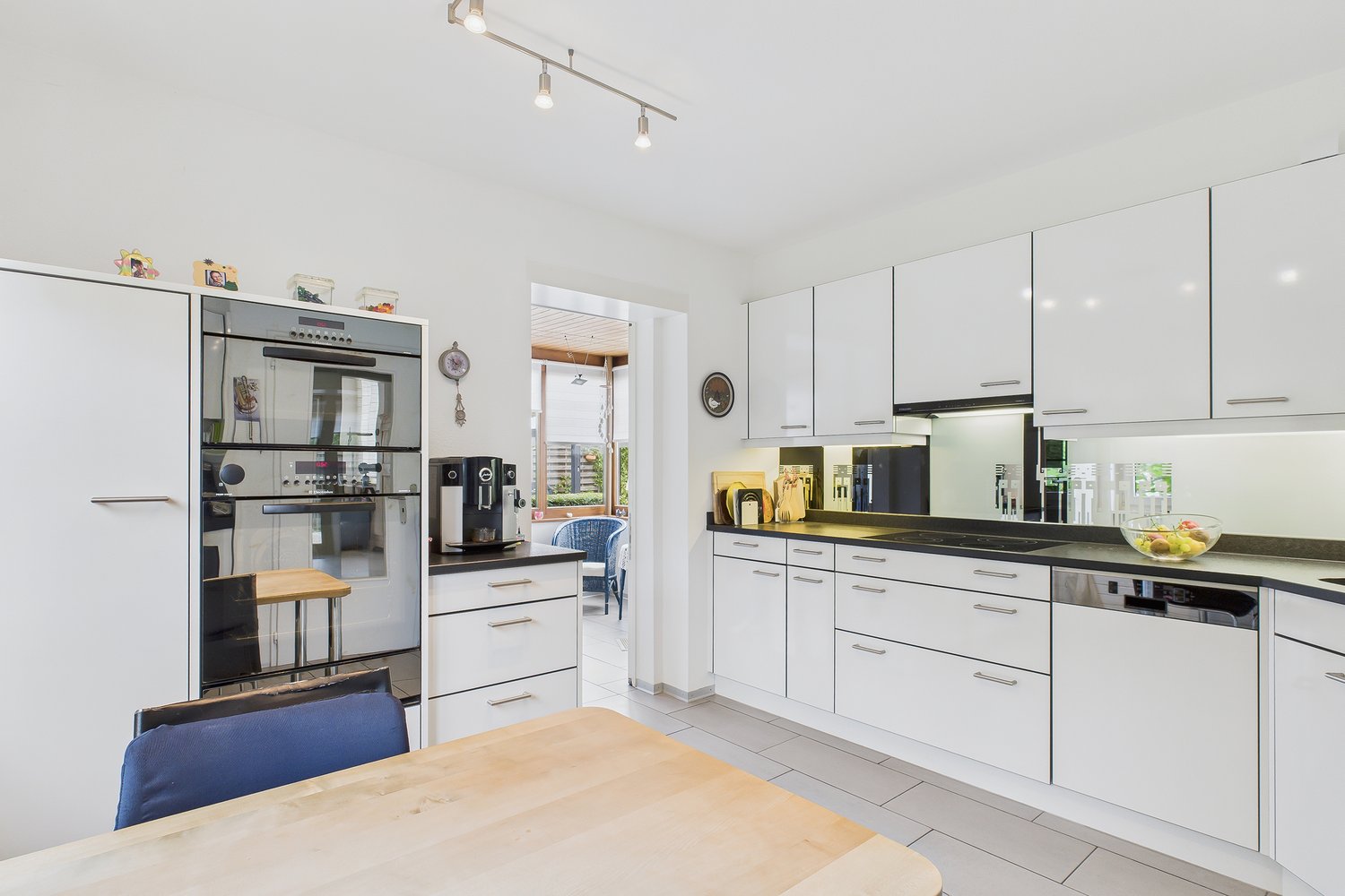 modern, all white, granite countertops, dishwasher, gas stove, coffee machine, two ovens, large sink