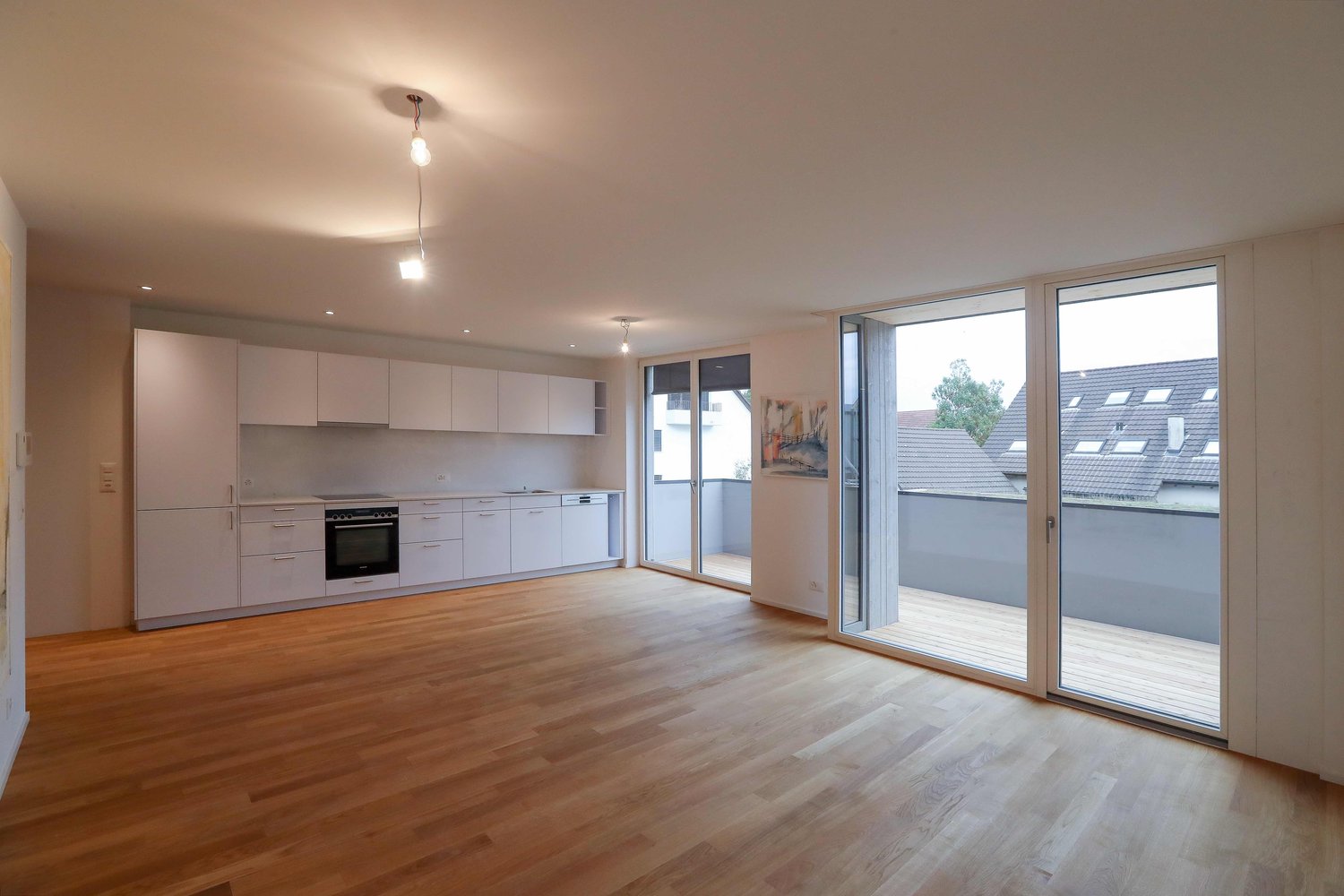 modern kitchen, balcony, sliding doors, wooden floor, white cabinets, white countertop, painting