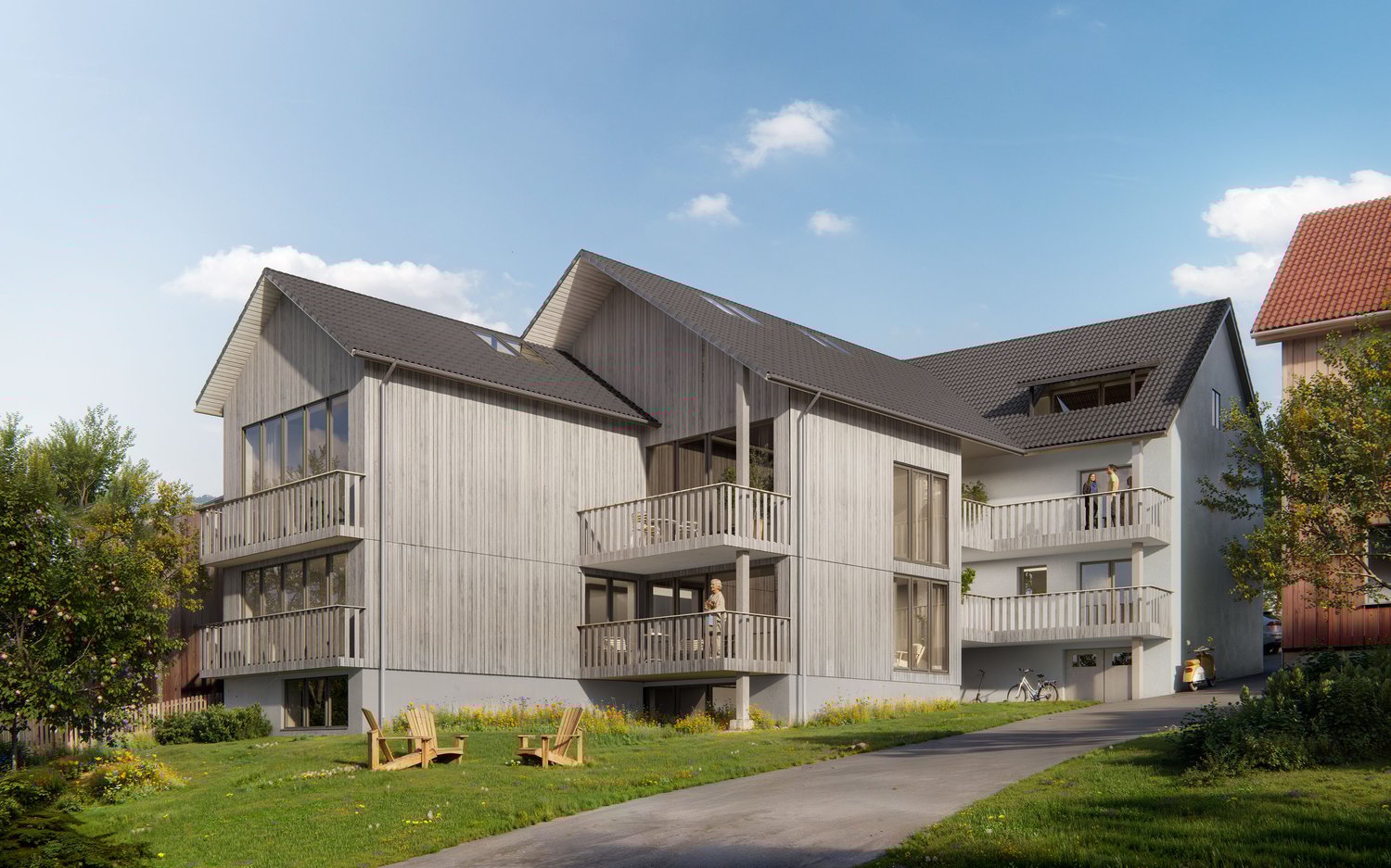 Modern apartment building with gray exterior, multiple balconies, green surroundings