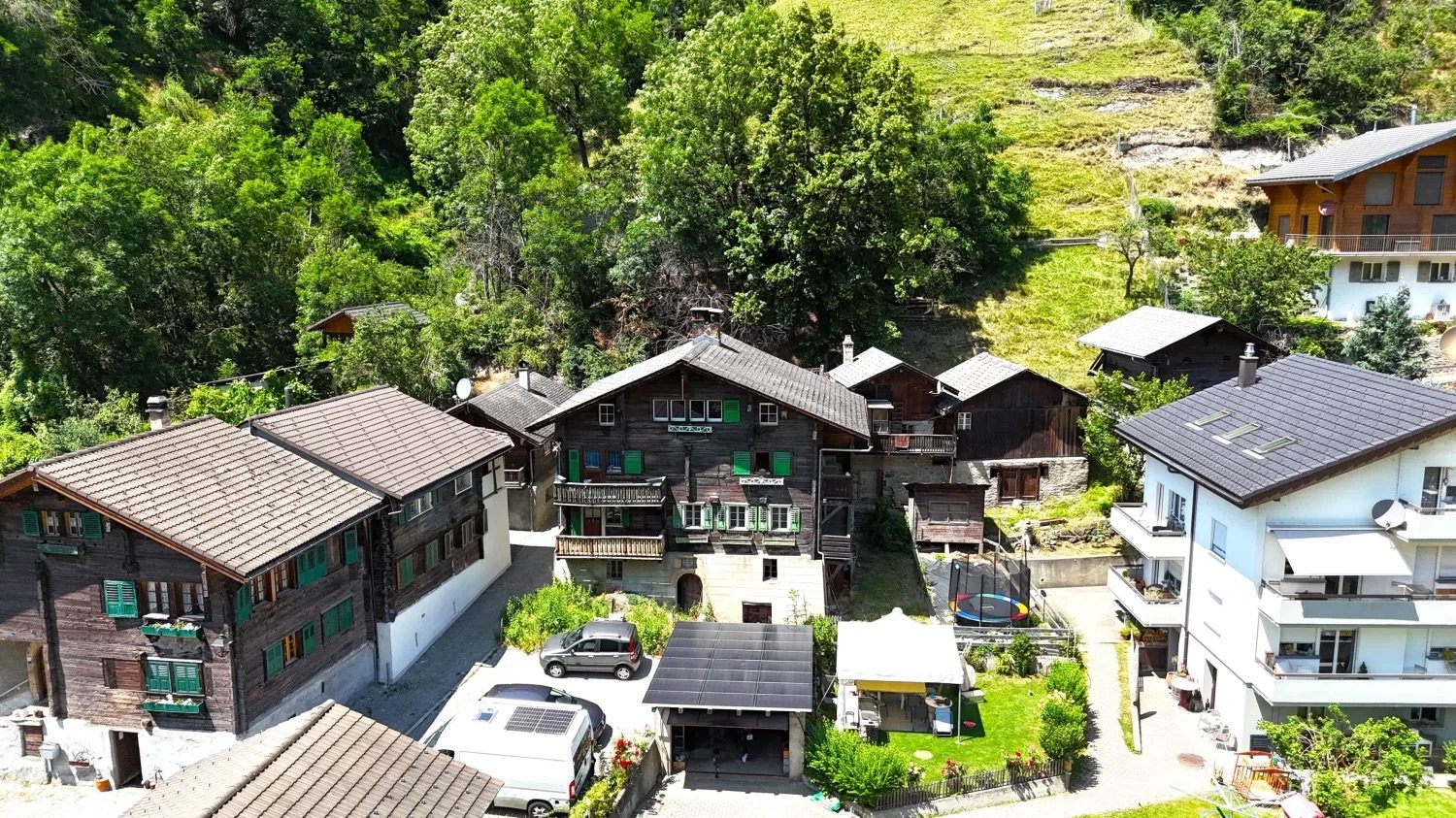 Mountain village, traditional wooden chalet, large garden, several buildings, panoramic views, solar panels, car parking