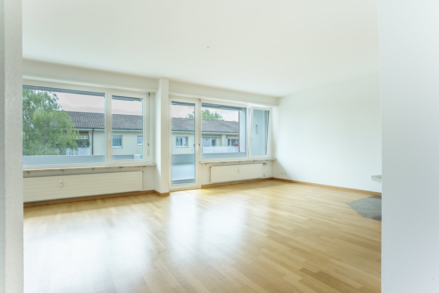 empty room, wooden floor, white walls, sliding windows, balcony