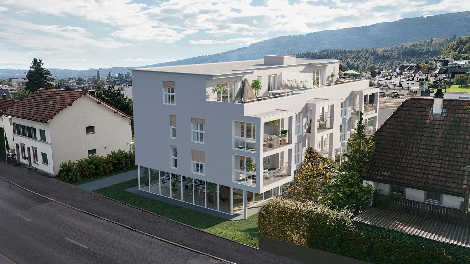 A modern, multi-story apartment building with a sleek, minimalist design. The building has several balconies and terraces, and is situated in a hilly, residential area with other buildings and greenery visible in the background.