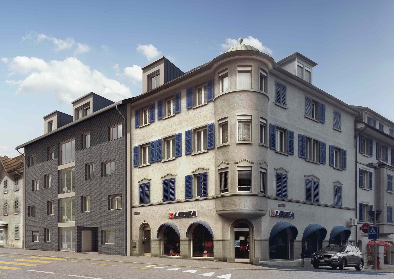 Three story building with many windows, blue shutters, dome-shaped roof and store fronts on the ground floor