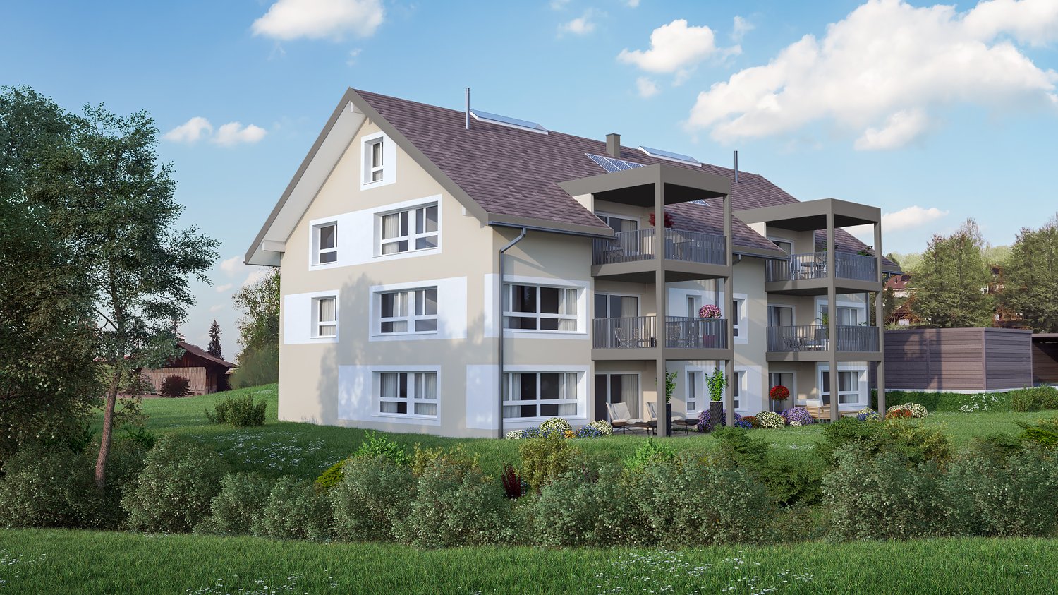 3-story apartment building with a slanted roof, white exterior walls, and multiple balconies. The building is surrounded by a grassy area with trees and flowers. There appears to be a parking area in front of the building.