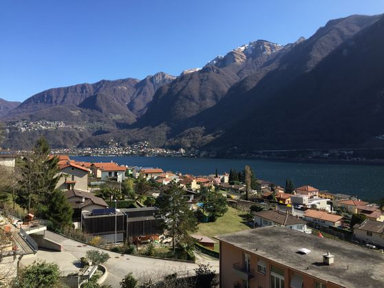 Mountain view, lake view, town view, multiple houses, trees, mountains