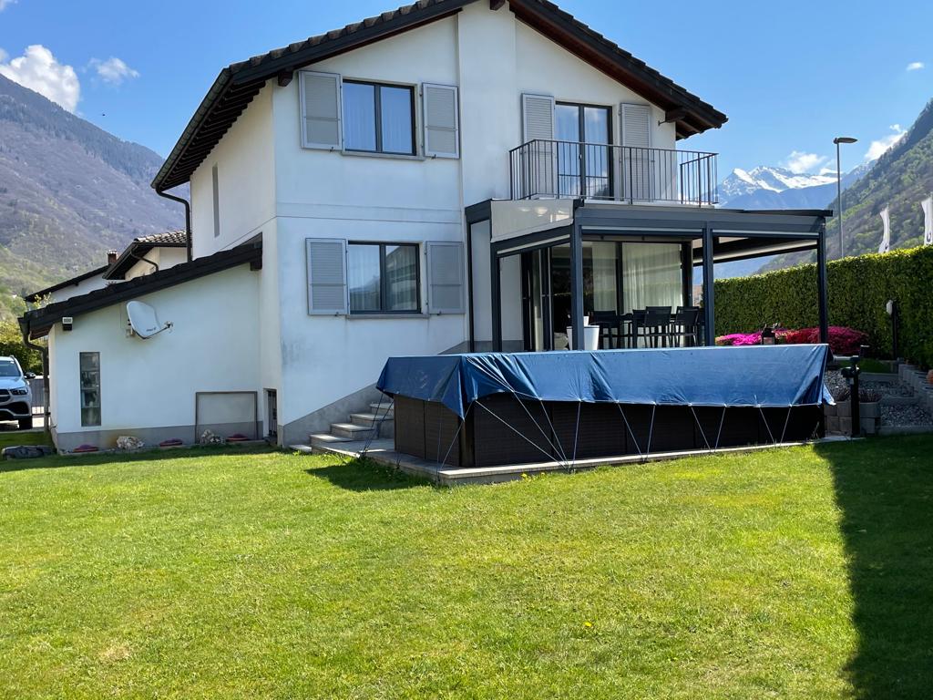 2 story house, white exterior, brown roof, balcony, swimming pool, green lawn, mountain view