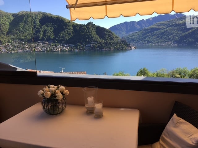 Table, chairs, flowers, lake view, mountains, candles