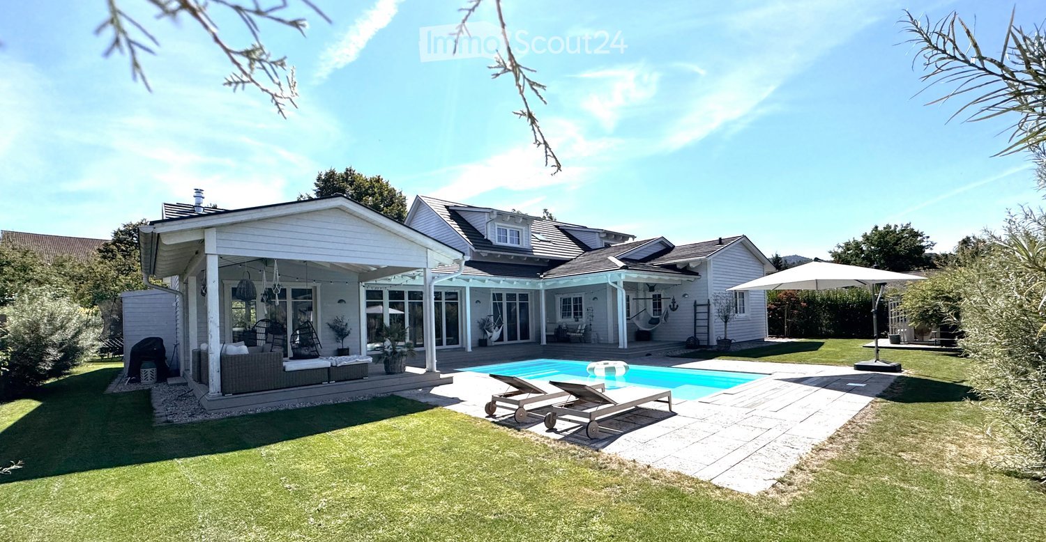 modern house, pool, grassy lawn, large pool with deck, outdoor lounging area, large patio, outdoor seating, patio umbrellas, hammock