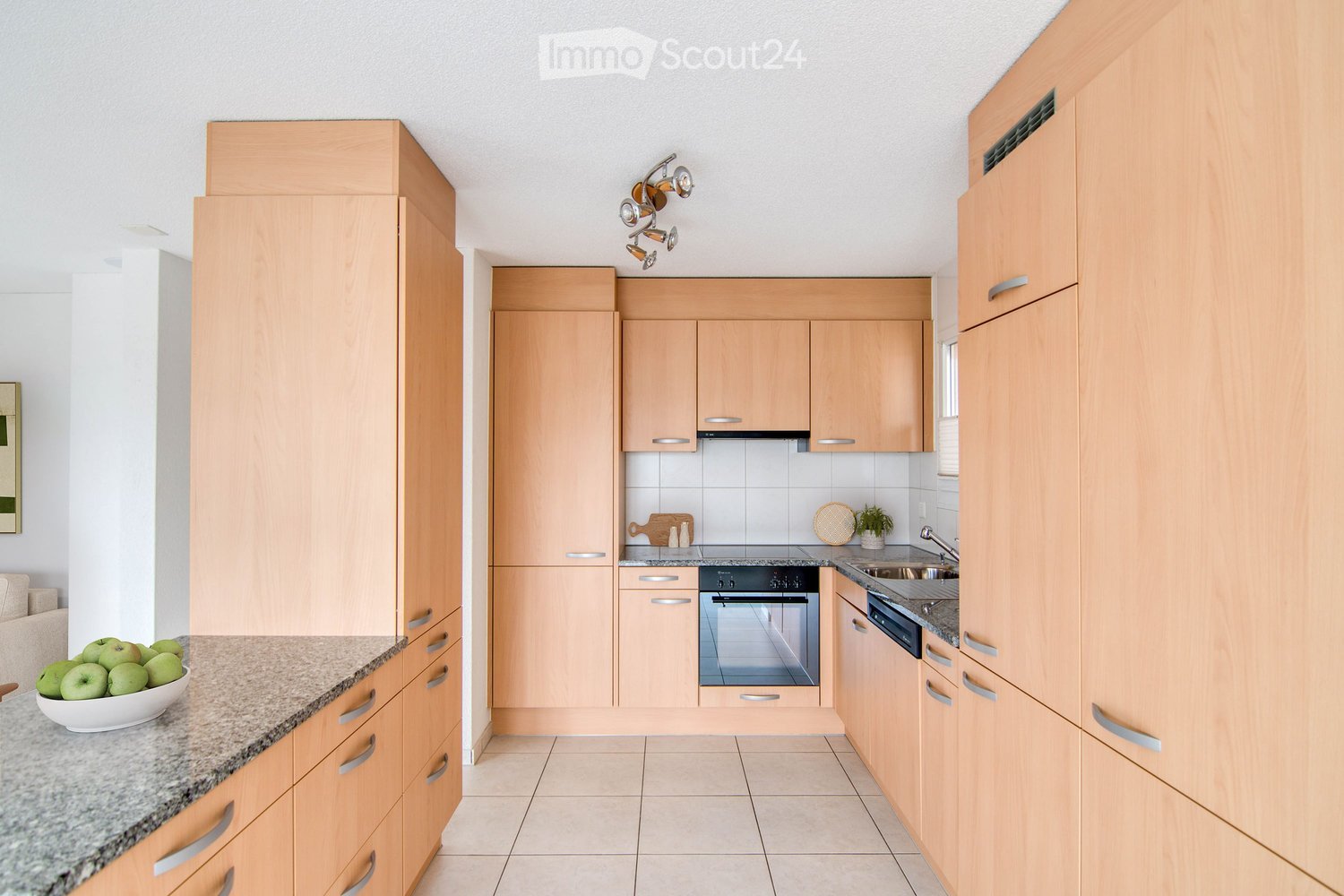 modern kitchen with wooden cabinets, granite countertops, stainless steel appliances, under-cabinet lighting, tile flooring, double oven and dishwasher