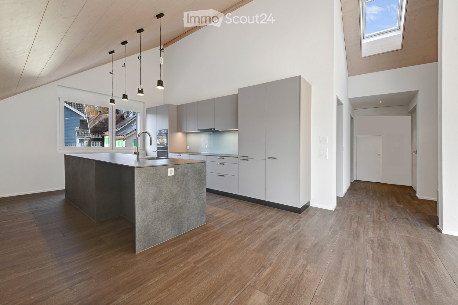 contemporary kitchen, grey cabinetry, wooden floor, island with double sink, hanging pendant lights