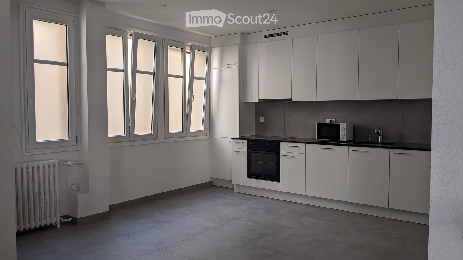 modern, white cabinetry, granite countertop, large windows, heating system