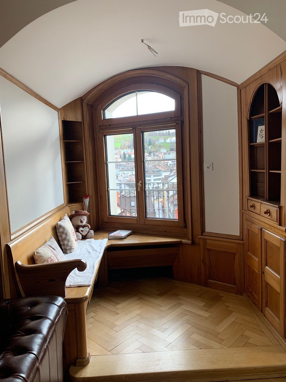 wooden interior, sofa, windows, bookshelves, wooden bench, teddy bear, cushion, book, brown leather chair