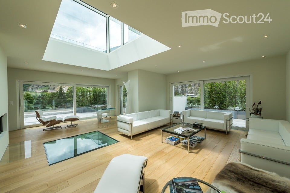 living room with large windows, modern interior, glass floor, skylight, couch, table, chair, white walls, wooden floor
