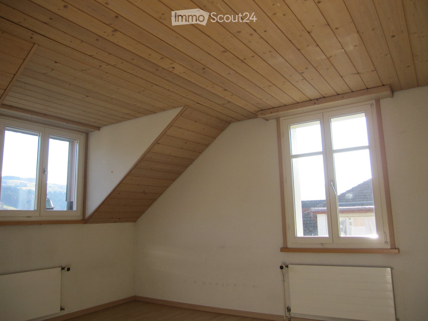 empty room, wooden ceiling, white walls, white windows, heaters, wooden floor, view to the outside