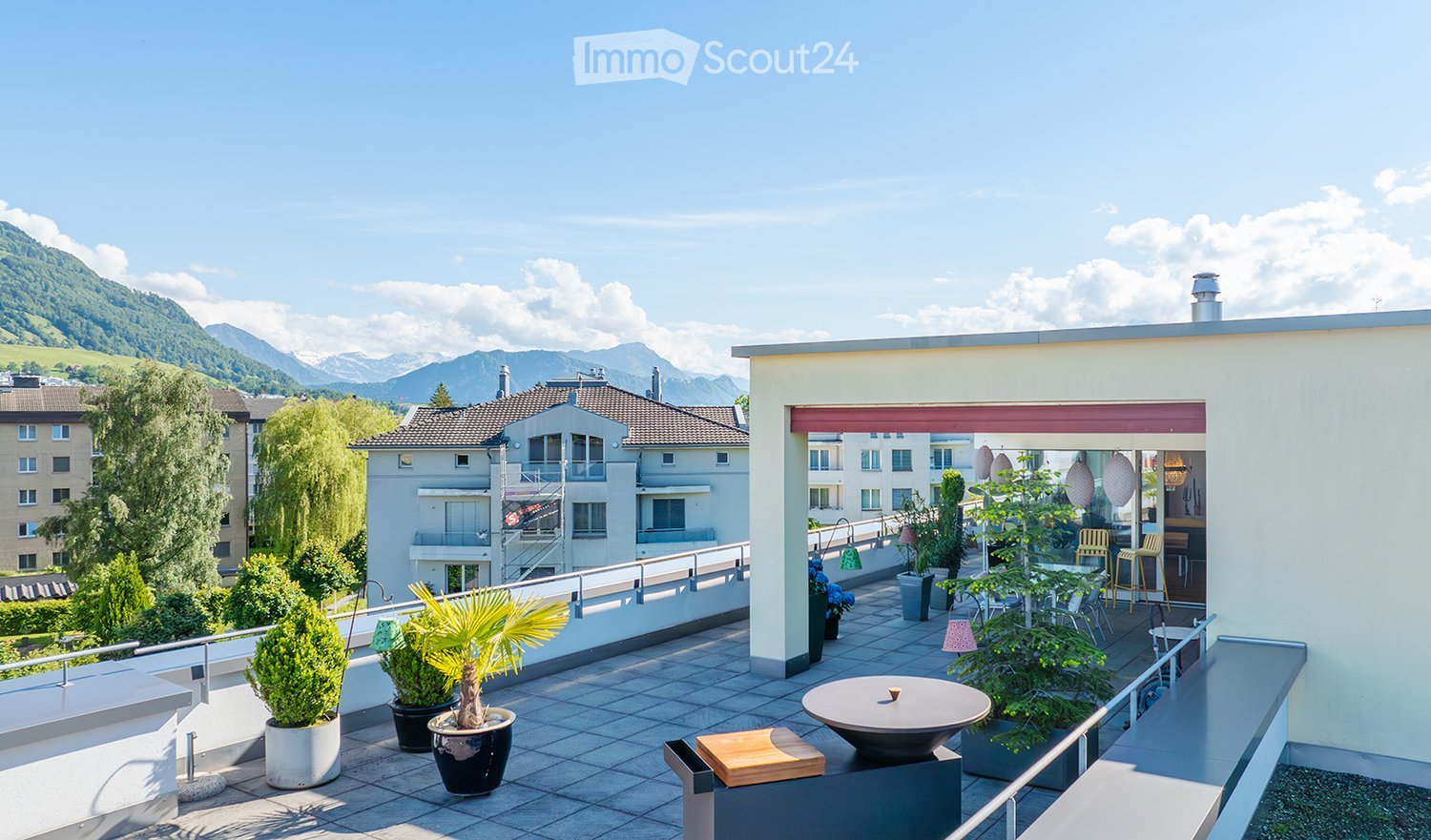 Apartment balcony with outdoor seating, mountain view