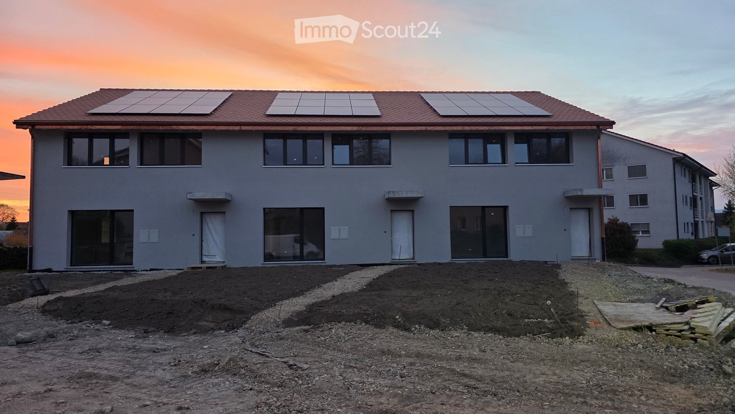 2 story house, solar panels, glass windows, gray exterior, red roof, balcony