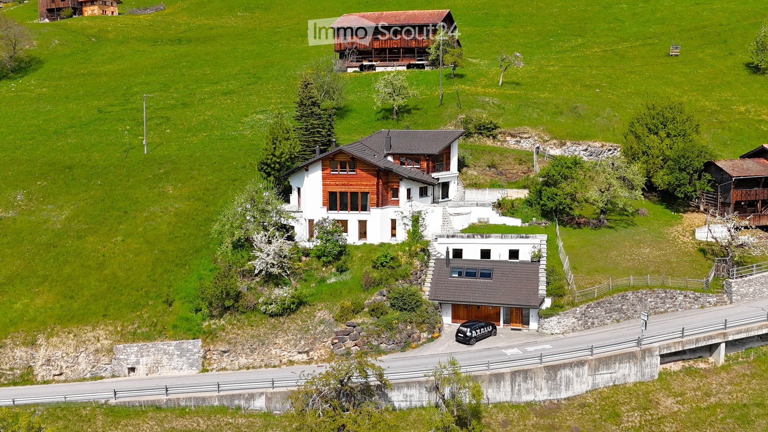 detached house, wood and white walls, garage, large green field