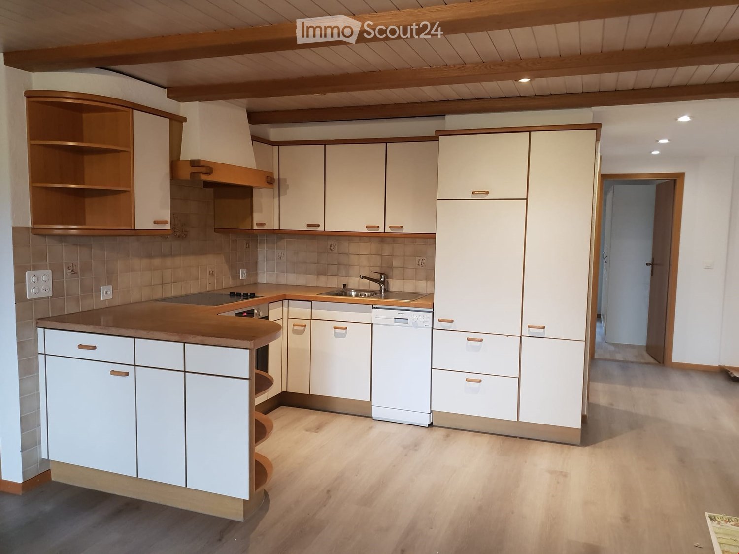 modern kitchen with gas stove, wooden counters, white cabinets, white sink, dishwasher