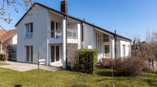 Modern 2 story house, white exterior, brown roof, double doors, windows, balcony