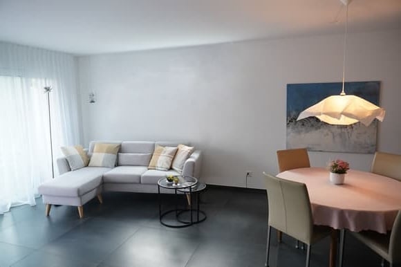 L-shaped sofa, round coffee table, dining table with 6 chairs, floor lamp, light fixture