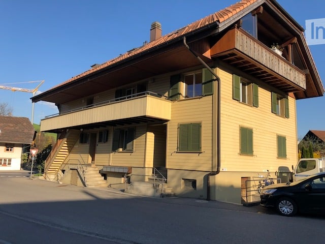 3 story house, yellow paint, green shutters, balcony, stairs