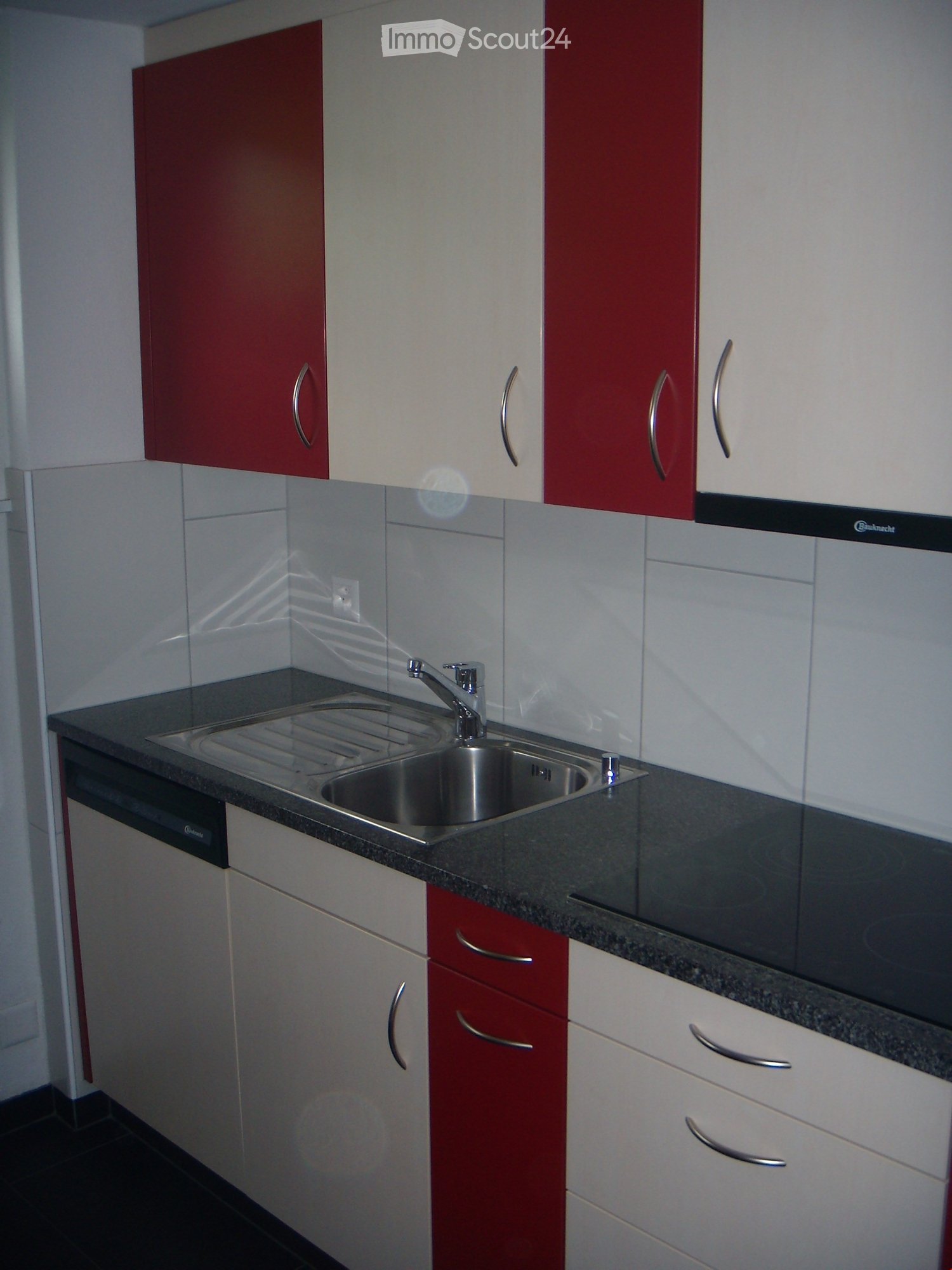 modern kitchen, stainless steel sink, granite countertops, dishwasher, wooden cabinetry, electrical outlet