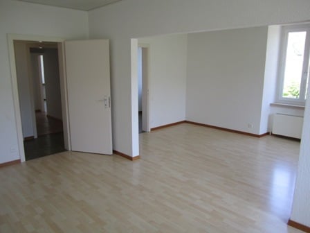 empty room, hardwood floor, white walls, door, window, heater