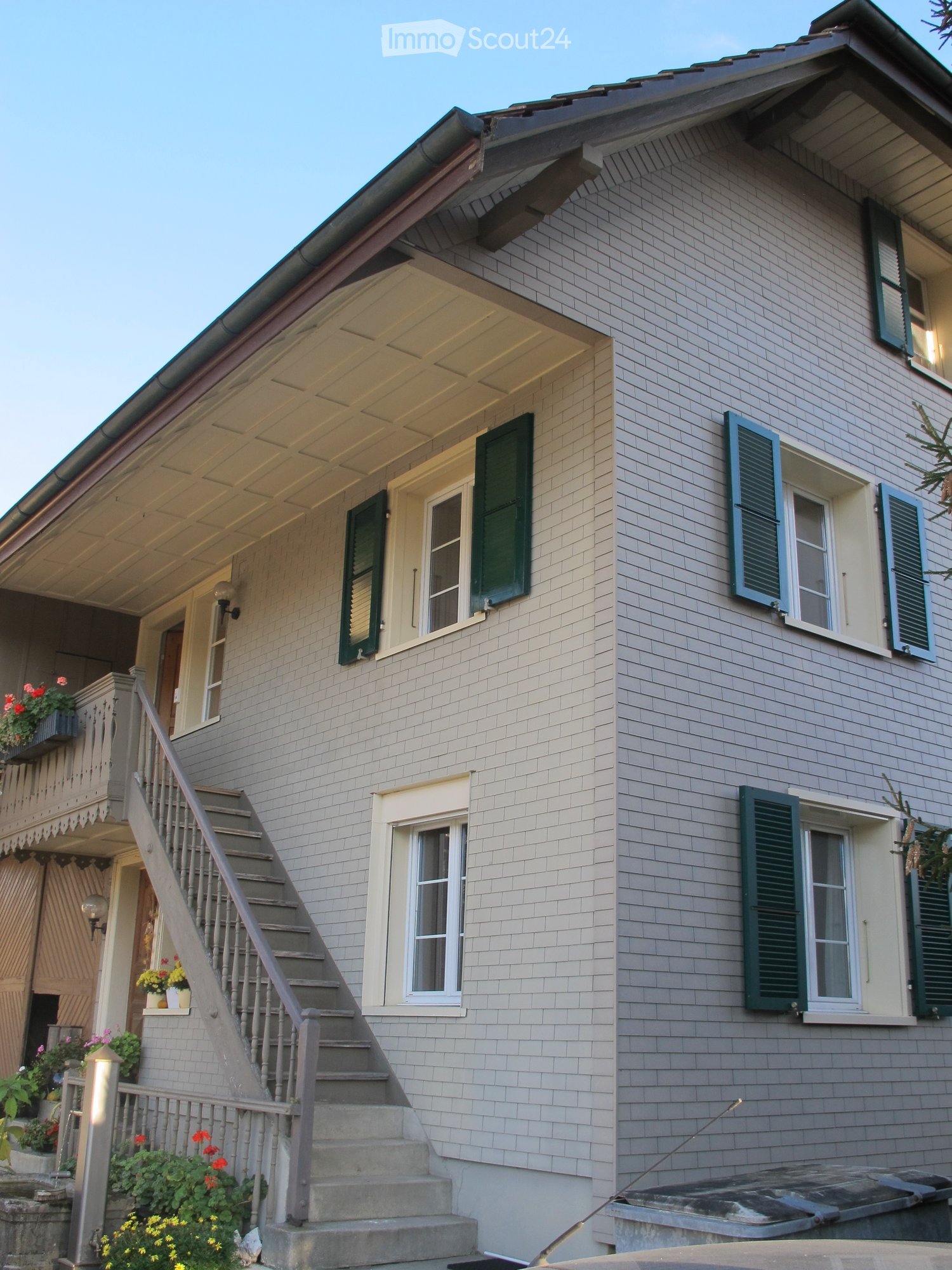two story house, brick, tiled roof, balcony, flower pots, staircase