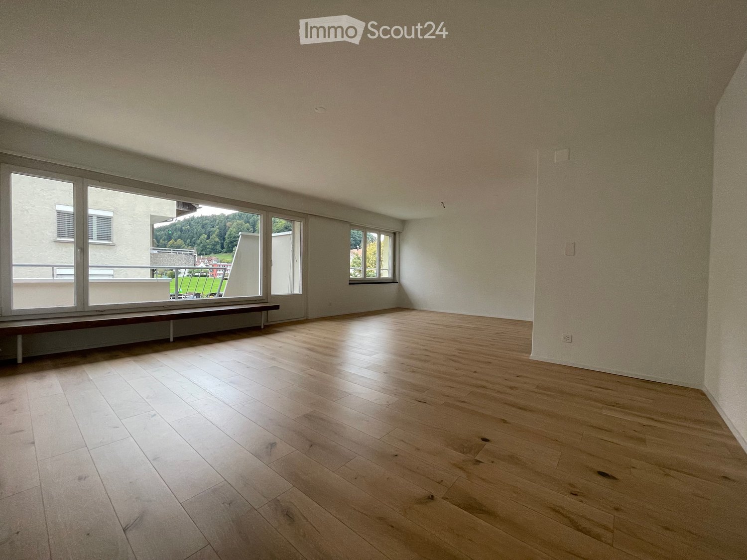 wooden floor, empty room, large windows, wooden bench, balcony